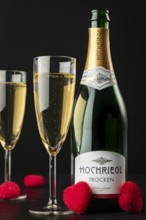 Close-up of champagne bottle and glasses with red hearts on black background