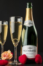Bottle and glasses with sparkling wine, with roses, hearts and ring in glass on black background