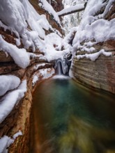 Taugl or Tauglbach flows through the snow-covered and icy red gorge, also Marmorklamm, Bad Vigaun,