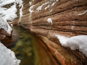 Taugl or Tauglbach flows through the snow-covered and icy red gorge, also Marmorklamm, Bad Vigaun,