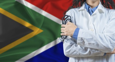 Healthcare professional with South Africa flag background. Professional doctor holding stethoscope