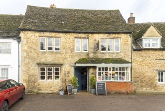 National Trust shop in historic Cotswold stone building, village of Lacock, Wiltshire, England, UK