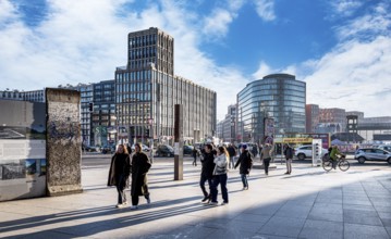 Wall segment, tourists and passers-by at Potsdamer Platz, Berlin, Germany