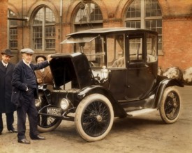 Thomas Alva Edison displaying storage batteries of the power Detroit Electric automobile, 1913,