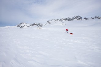 A tourist on a winter Arctic expedition skiing along Ikasartivaq Fjord, Sermersooq municipality,