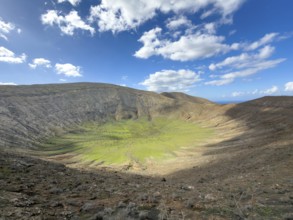 View of the Caldera Blanca volcano cauldron against blue sky with white clouds, Mancha Blanca,