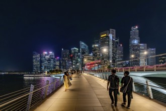 Skyline of the Central Business District, CBD with illuminated skyscrapers and Jubilee Bridge in