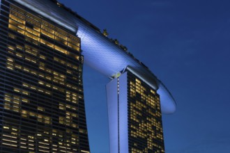 Marina Bay Sands, MBS, luxury 5-star hotel and integrated resort illuminated at dusk in Downtown