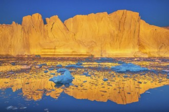 Icebergs at sunset in the Ilulissat Icefjord near the town of Ilulissat, a UNESCO World Heritage