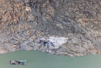 Remains of the Rhone Glacier ice cave covered with protective white geotextile sheets, highlighting