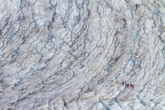 Mountaineers walk on the Rhone Glacier, highlighting climate change and global warming, Oberwald,