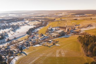 Wide winter field landscape with buildings and horizon at sunrise, Hallwangen, Freudenstadt