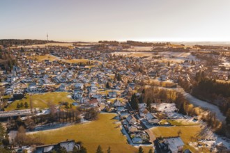 Aerial view of a sprawling settlement in winter with snowy fields and soft light, Hallwangen,