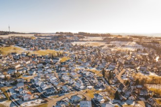 Bird's-eye view of rural winter landscape with snow-covered houses and fields, Hallwangen,