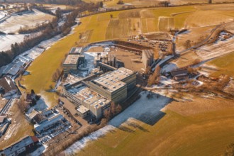 Industrial complex surrounded by wintry fields and snow-covered areas, Hallwangen, Freudenstadt