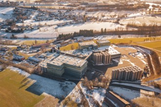 Industrial area with snow-covered fields and buildings from a bird's eye view, Hallwangen,
