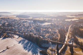 Winter landscape with snow-covered village, fields and a bridge under sunny sky, Aach, Dornstetten,