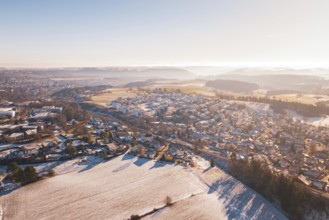 Aerial view of a snowy village in hilly landscape under bright sky, Aach, Dornstetten, Freudenstadt