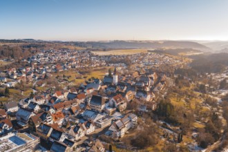 Impressive aerial view of a town with a central church, wide valley in sunlight, Dornstetten,