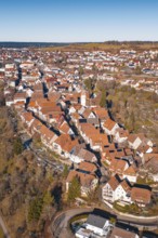 Aerial view of dense buildings with red roof tiles in a wintry environment, Dornstetten,