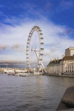 Cityscape with Ferris wheel on riverbank in good weather, London Eye, London, United Kingdom