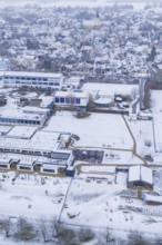 Aerial view of a sprawling village with snowy roofs and roads, Empfingen, Freudenstadt district,