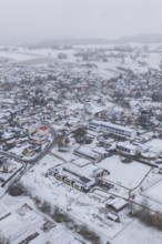Aerial view of a snowy village with houses, roads and surrounding fields, Empfingen, Freudenstadt