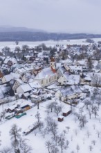 Snowy village with church in the center, surrounded by trees, winter landscape, Wiesenstetten,