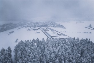 Aerial view of a snowy village surrounded by forests, Hörschweiler, Freudenstadt district, Germany
