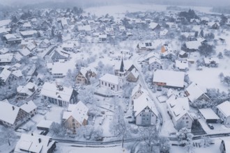 Snowy village with a church wrapped in a cold, peaceful atmosphere, Schopfloch, Freudenstadt