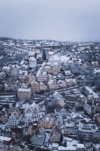 Snow-covered town with numerous half-timbered houses and a distinctive church, Altensteig, Calw