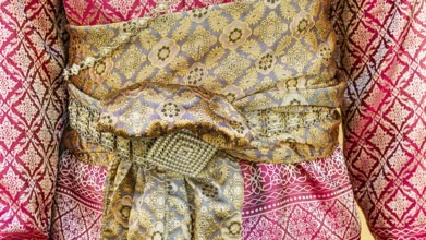 Traditional Thai woman's clothing with tied sash, Bangkok, Thailand's metropolis, Thailand