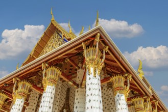 Columns with floral motifs support the gold-colored ceiling of the Wat Arun Buddhist temple,