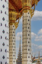 Columns with floral motifs support the gold-colored ceiling of the Wat Arun Buddhist temple,