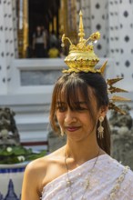Young woman with traditional headdress, wearing traditional clothing, presenting herself to the