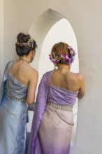 Young woman with traditional headdress, wearing traditional clothing, present themselves for the