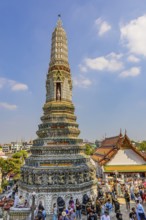 Pagoda with ceramic inlays surrounded by visitors and tourists, Wat Arun Buddhist temple, Bangkok,