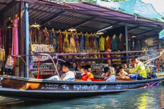 Wooden boat with tourists on the Damneon Saduak floating markets channel, near Bangkok, Ratchaburi