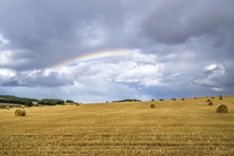Rainbow over Straw bales, Scottish fields, Southeast Scotland, UK
