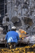 Workers with cutting torches demolishing the 120-meter long motorway bridge of the A516, across