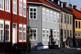 Lively street scene with colorful wooden houses, Trondheim, Trøndelag, Norway