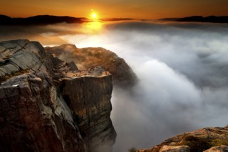 Magical sunrise over misty rocks near Prekestolen