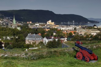 View from Kristianstenfestning over Trondheim with red cannon in the foreground, Trondheim, Norway