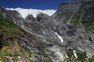 Majestic glacier tongue of Supphellebreen surrounded by rugged mountain terrain