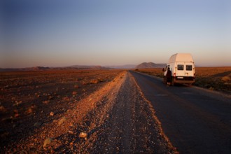 Transporter on lonely road in breathtaking evening scenery, Gourrama, Morocco
