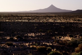 Volcano-like mountain rises from pristine desert landscape, Gourrama, Morocco