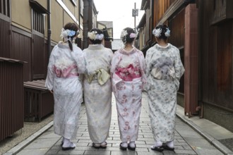 Four woman in kimonos walk through Nakamachi Street in Gion, Gion, Kyoto, Japan