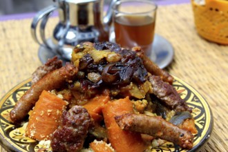 Close-up of a traditional Moroccan couscous dish with tea, Essaouira, Morocco