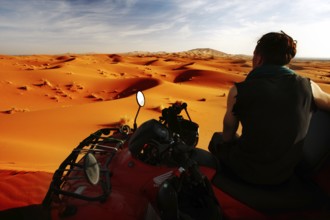 View from a quad bike over impressive orange desert sand dunes, Erg Chebbi, Morocco