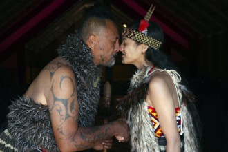 Hongi ceremony between two Maori in traditional dress, Rotorua, Te Puia, New Zealand
